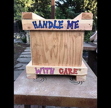 Handle Me With Care drawn on the bottom of a shipping crate.