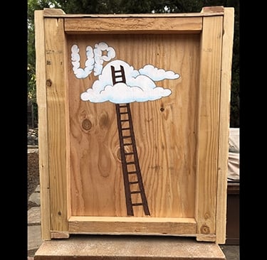 Shipping crate for Talbotics sculpture with image of ladder into the clouds drawn on it.