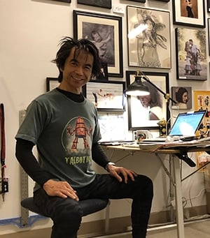 Talbotics t-shirt wearer working at desk.