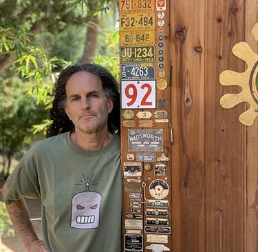 Artist Tal Avitzur standing by his workshop door.