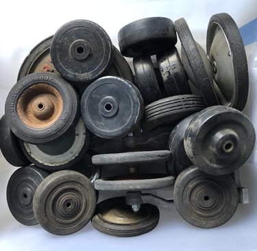 A bin full of tires from children's toys inside an assemblage artist's studio.