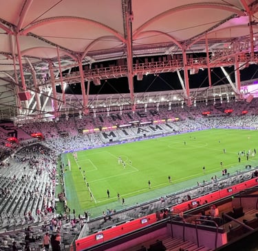 Aerial view of Chase Stadium in Fort Lauderdale during an Inter Miami soccer match at night.
