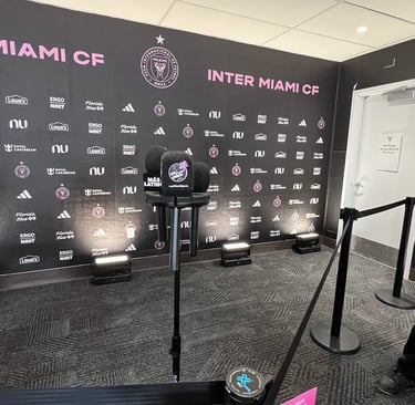 Inter Miami CF press conference room with microphones and branded backdrop at Chase Stadium.