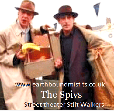 The Spivs street theater performers on stilts wearing vintage trench coats and hats.