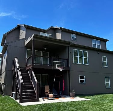 Finished modern exterior paint job with white window trim Blue Springs