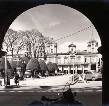 Vintage view of Leon, Guanajuato, Mexico, featuring historic architecture and park through an archway.