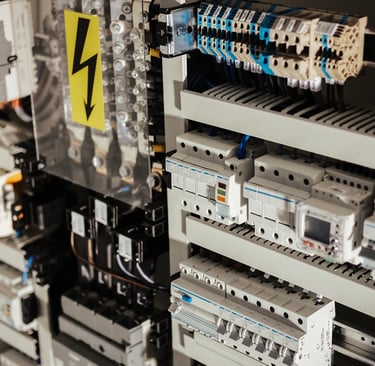Electrical control panel with circuit breakers and wiring components.