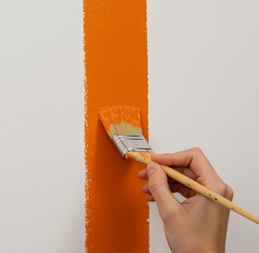 a person painting a wall with a paintbrush