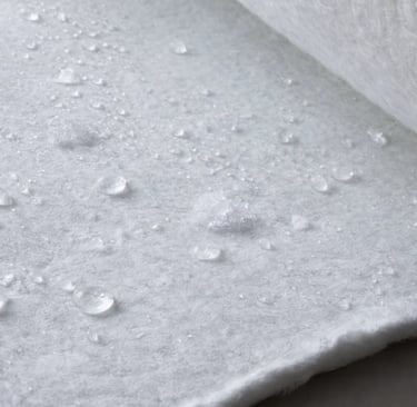 a close up of a sheet of Aerogel covered with water droplets