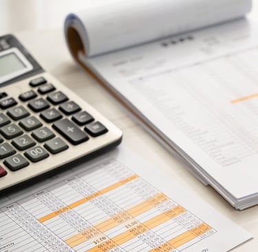 a calculator and a notebook on a desk