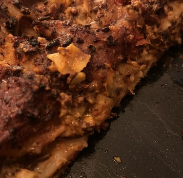 Homemade baked lasagna with a crispy, charred cheese crust and layers of rich meat sauce.