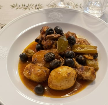 Braised chicken stew with roasted potatoes, black olives, and celery in a savory sauce.