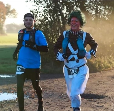 James Oswald Two Ultra marathon runners racing outdoors, including one man as an Oompa Loompa