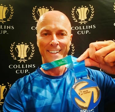 James Oswald Coaching holding a World Triathlon Silver medal World Championship & Collins Cup event.