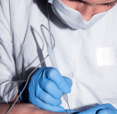 Dermatologist performing Mohs surgery to remove skin cancer while preserving healthy tissue.