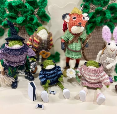 a group of knitted little animal ornaments
