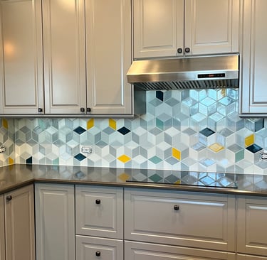 Modern kitchen featuring grey cabinets, a stainless steel range hood, and a geometric 3D cube tile backsplash.