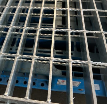 a metal grate with a metal grate and a blue and white background