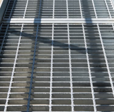 a metal grate with a metal grate and a metal grate