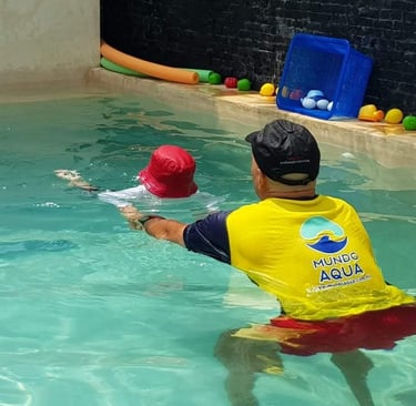 a man in a yellow shirt is playing with a ball in the water