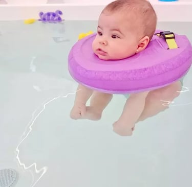 a baby in a tubtub with a purple float ring