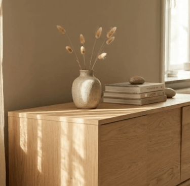 Madia in legno naturale con decorazioni essenziali e luce naturale soffusa