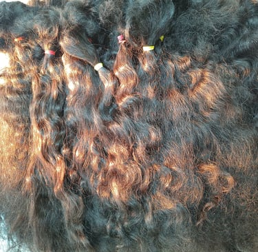 Raw human hair material being carefully segregated by texture and length at Tanori Hair LLP before the manufacturing process