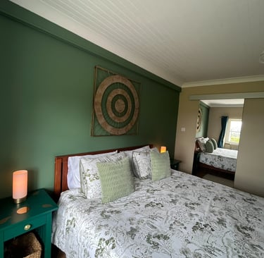 Green room's super king-size bed. Full length mirror