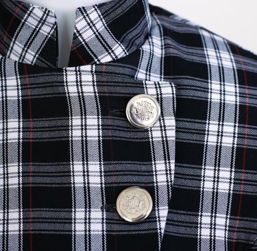 Details of Rogue Coat showing metal buttons and tartan details