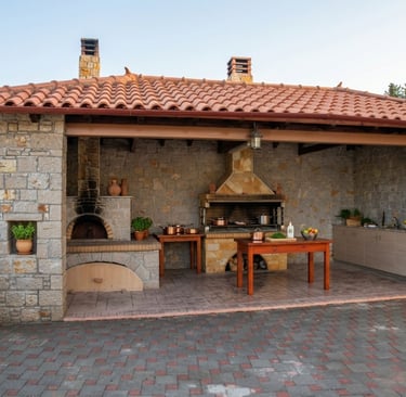 Outdoor kitchen with a stone pizza oven, built-in grill, and terracotta roof. BBQ.