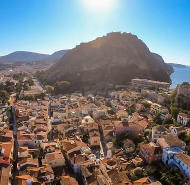 Aerial view of Nafplio old town and Palamidi Fortress under a bright sun in Greece.
