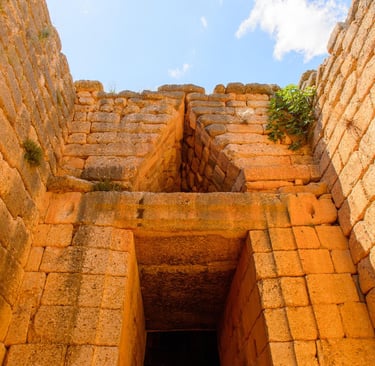 Ancient stone entrance at the Mycenaean Treasury of Atreus beehive tomb in Greece.