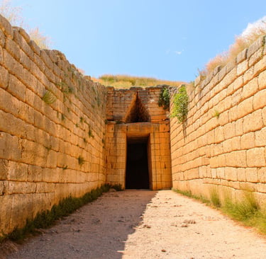 The ancient stone entrance to the Treasury of Atreus beehive tomb in Mycenae, Greece.