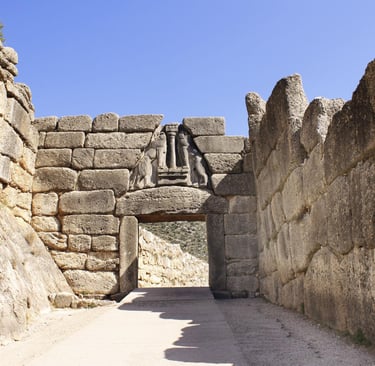 The ancient Lion Gate of Mycenae featuring a stone relief sculpture and Cyclopean masonry walls in Greece.