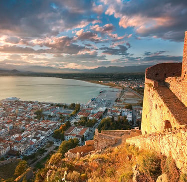 Golden sunset over the historic Palamidi Fortress overlooking the city of Nafplio and the Argolic Gulf in Greece.