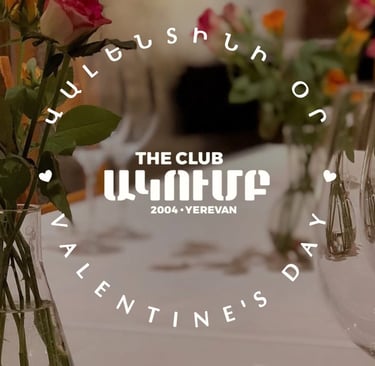 Elegant Valentine's Day dinner table setting at The Club Yerevan with roses and wine glasses.