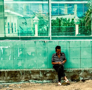 Man Lighting a cigarette in Saigon.