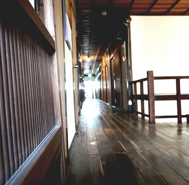 The warm texture of aged wooden flooring at Nakadaya, an authentic Japanese inn.