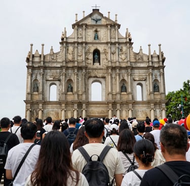 Iconic Zhuhai landmark illuminated at night with reflections on water.