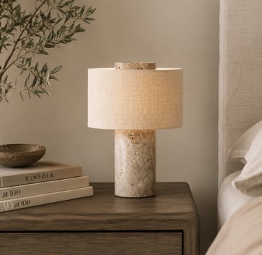 Natural stone and linen bedside table lamp styled in a warm organic luxury bedroom interior