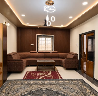 Modern living room featuring a brown sectional sofa, wood slat wall, and elegant chandelier lighting.