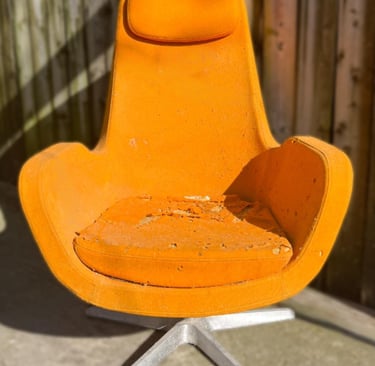 vintage Ikea 'Karlstad' chair in orange wool with many holes and foam damage