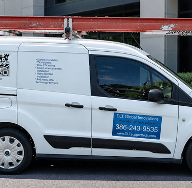 White DLT service van with roof ladder for Starlink and smart security camera installation.