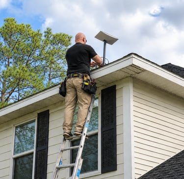 DLT technician mounting Starlink dish on residential roof