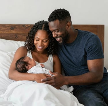 A doula gently supporting a mother during early labor in a softly lit room.