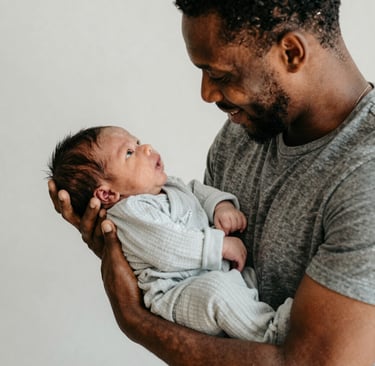 A doula training workshop with participants practicing supportive techniques in a bright studio.
