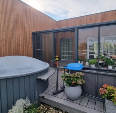 a hot tub with a blue umbrella and a blue umbrella