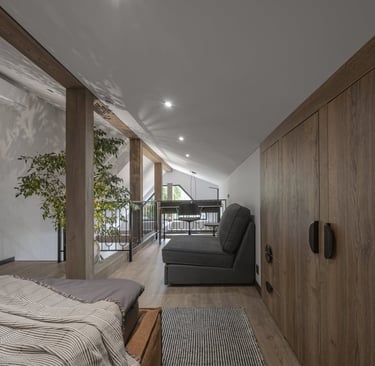 a bedroom with a bed and a couch