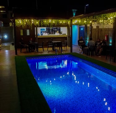 Inviting swimming pool area surrounded by lush greenery.