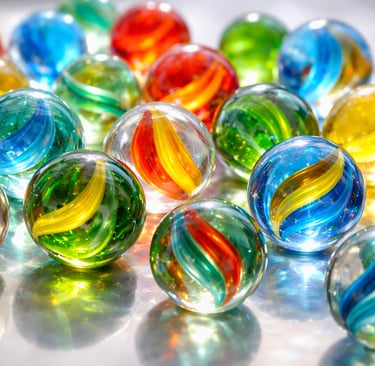 Brightly colored glass marbles on a shiny surface